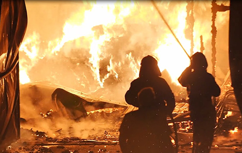 Firemen battle a roaring fire